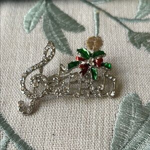 Elegant Silver and Green Music Note Brooch